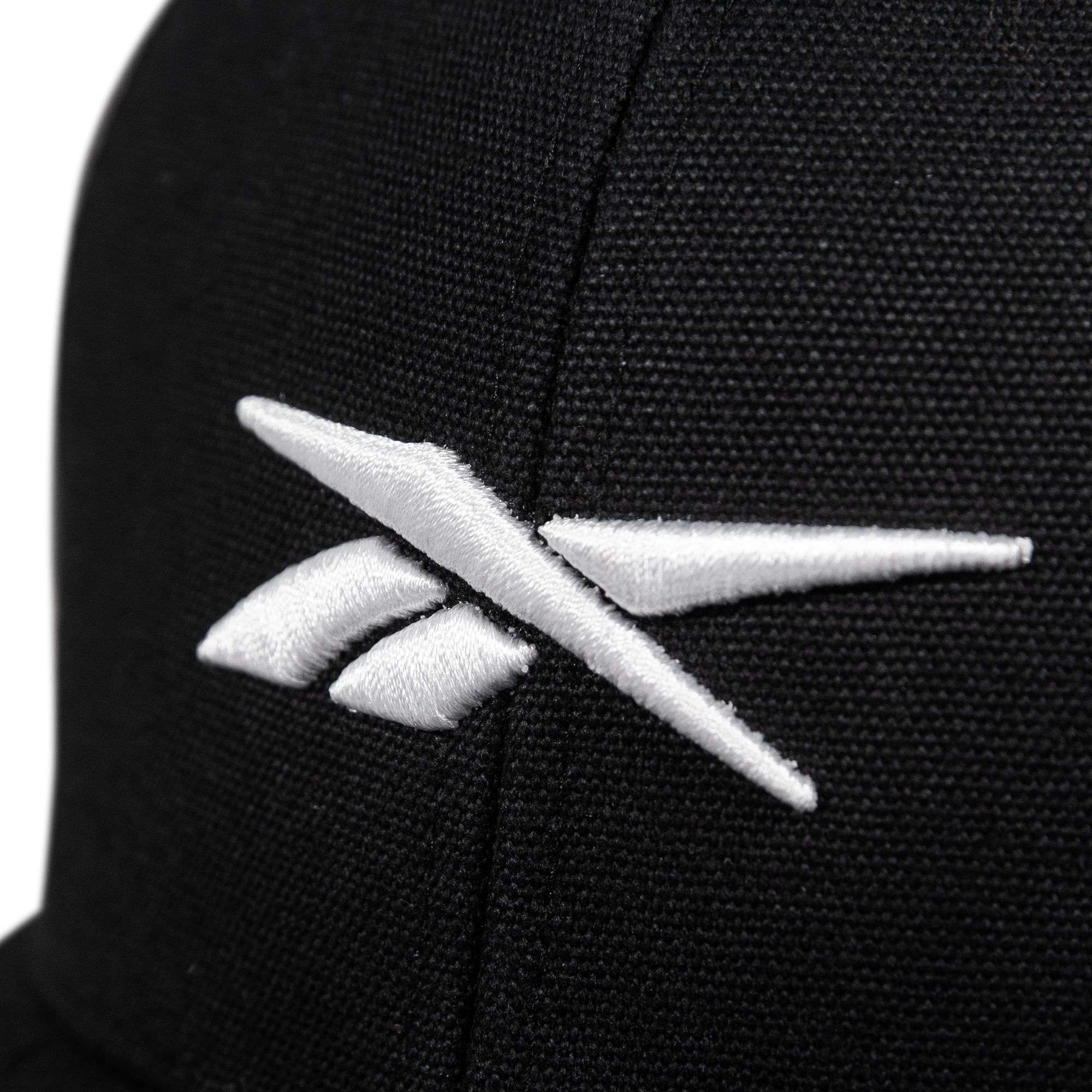 Close-up of the Reebok Embroidered Vector Trucker Cap, a black fabric hat with a white embroidered Reebok logo on the front.