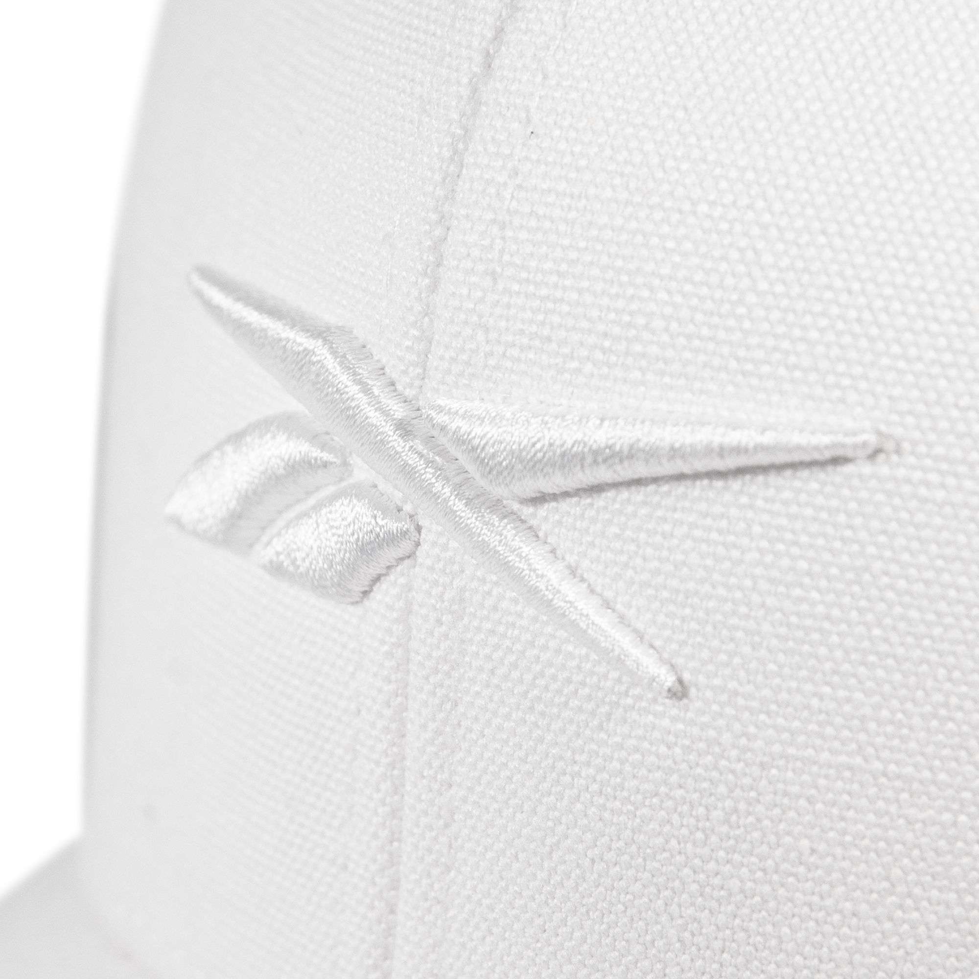 Close-up of the Embroidered Vector Trucker Cap by Reebok, showing a white fabric surface with the Reebok logo stitched in white thread.