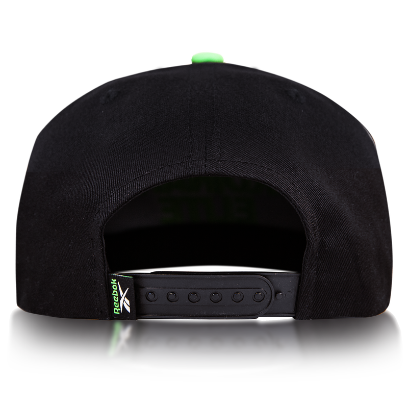 Rear view of the Reebok Ordinary Elite Cap, featuring a cotton crown, adjustable snapback plastic strap, and a small green Reebok logo tag on the left side. Shown against a plain white background.