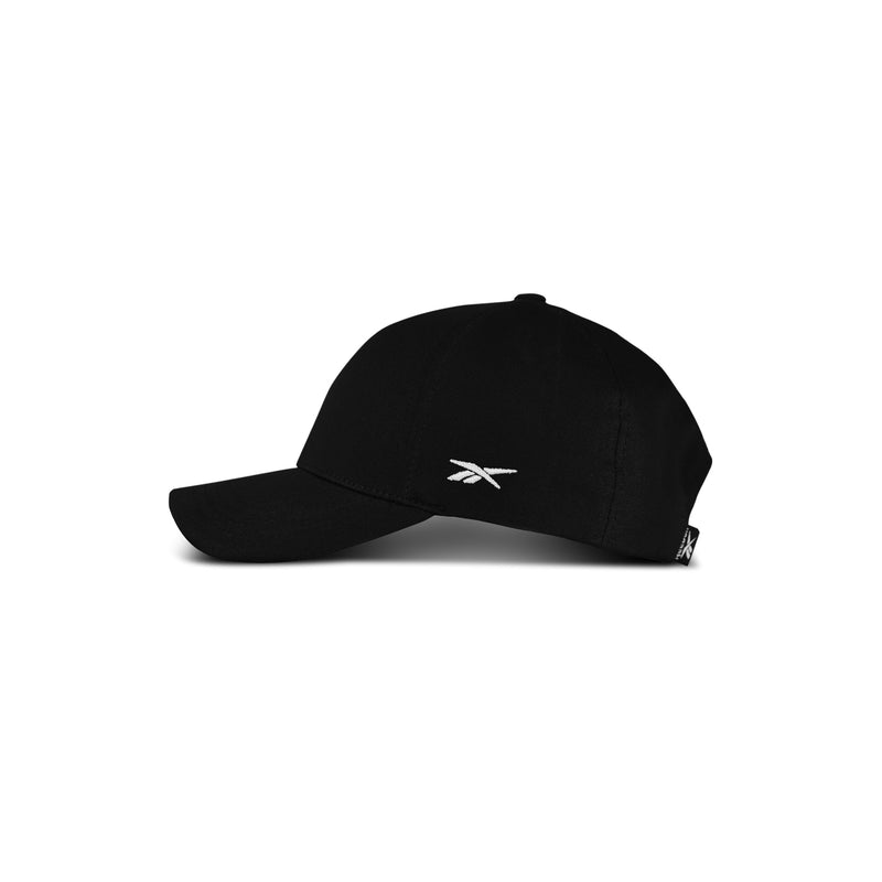 The Reebok Chroma Cap is a black cotton twill hat with a curved brim, adjustable snapback, and small white Reebok logo on the front. Shown against a white background.