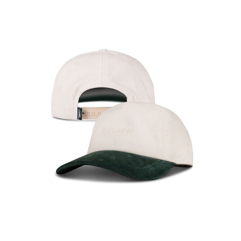 The Reebok Logo Corduroy Cap in beige features a dark green corduroy brim, subtle embroidered text on the front, and an adjustable snapback for comfort. Shown from both front and back views.