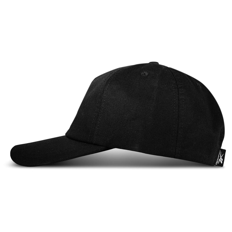 The Reebok Logo S-Vector Cap, made of cotton twill, features a plain black design with a curved brim, an adjustable snapback closure, and a small black and white side tag, shown against a white background.