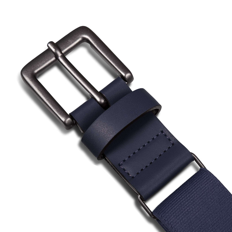 Close-up of the Reebok Youth Baseball Belt in navy blue, featuring a matte black buckle, detailed stitching, and a smooth leather loop—ideal for youth uniforms—shown against a white background.