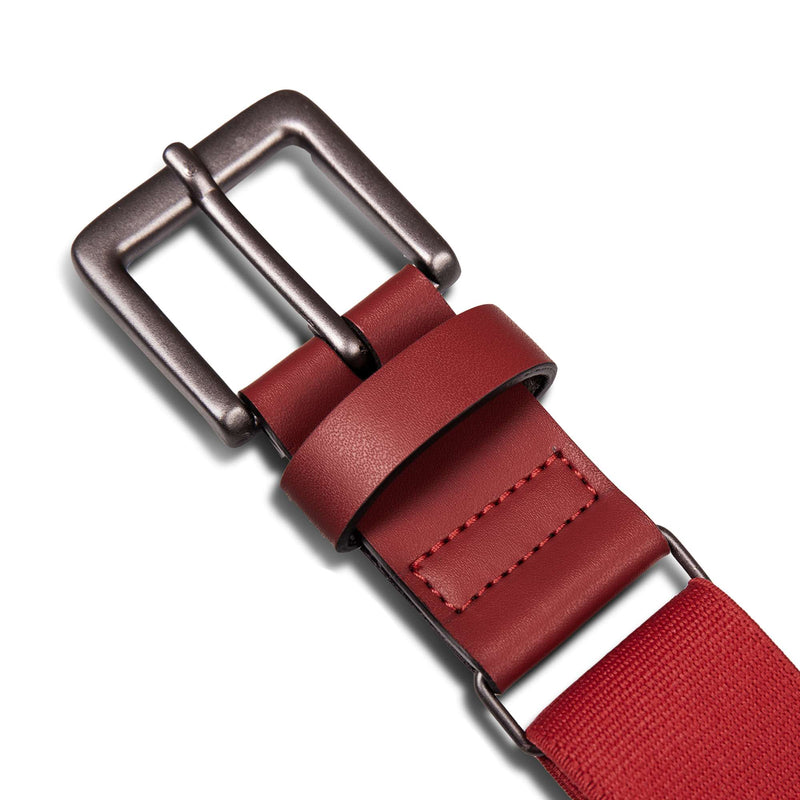 Close-up of the Reebok Youth Baseball Belt in red, featuring a stretch elastic strap, matte silver metal buckle, detailed stitching near the end, and rounded edges.