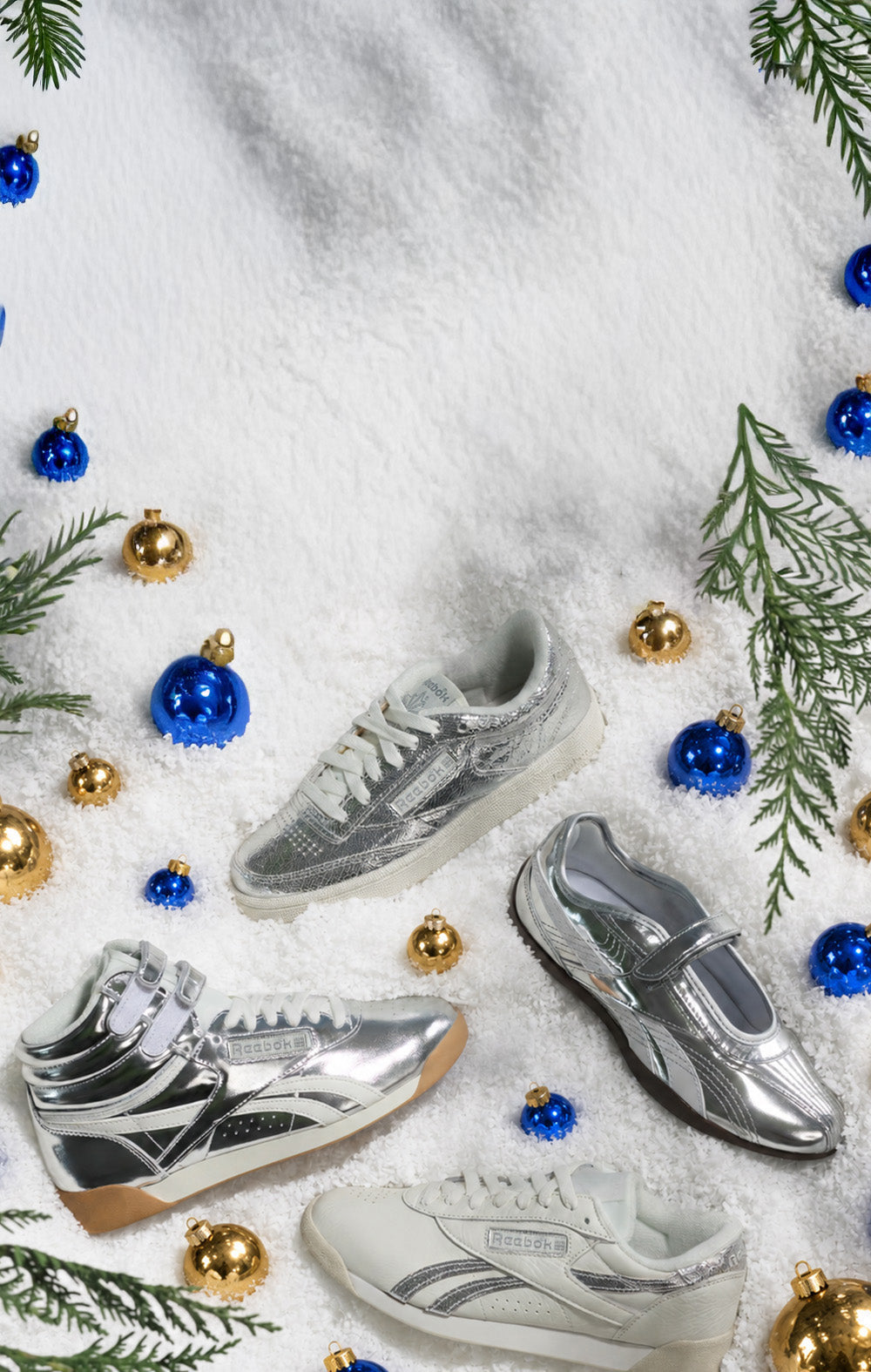 silver reebok shoes in snow with ornaments