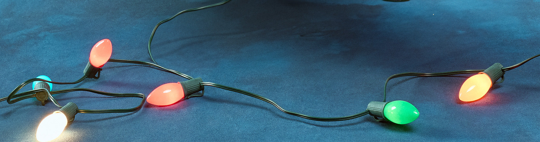 String of Christmas lights on a blue background