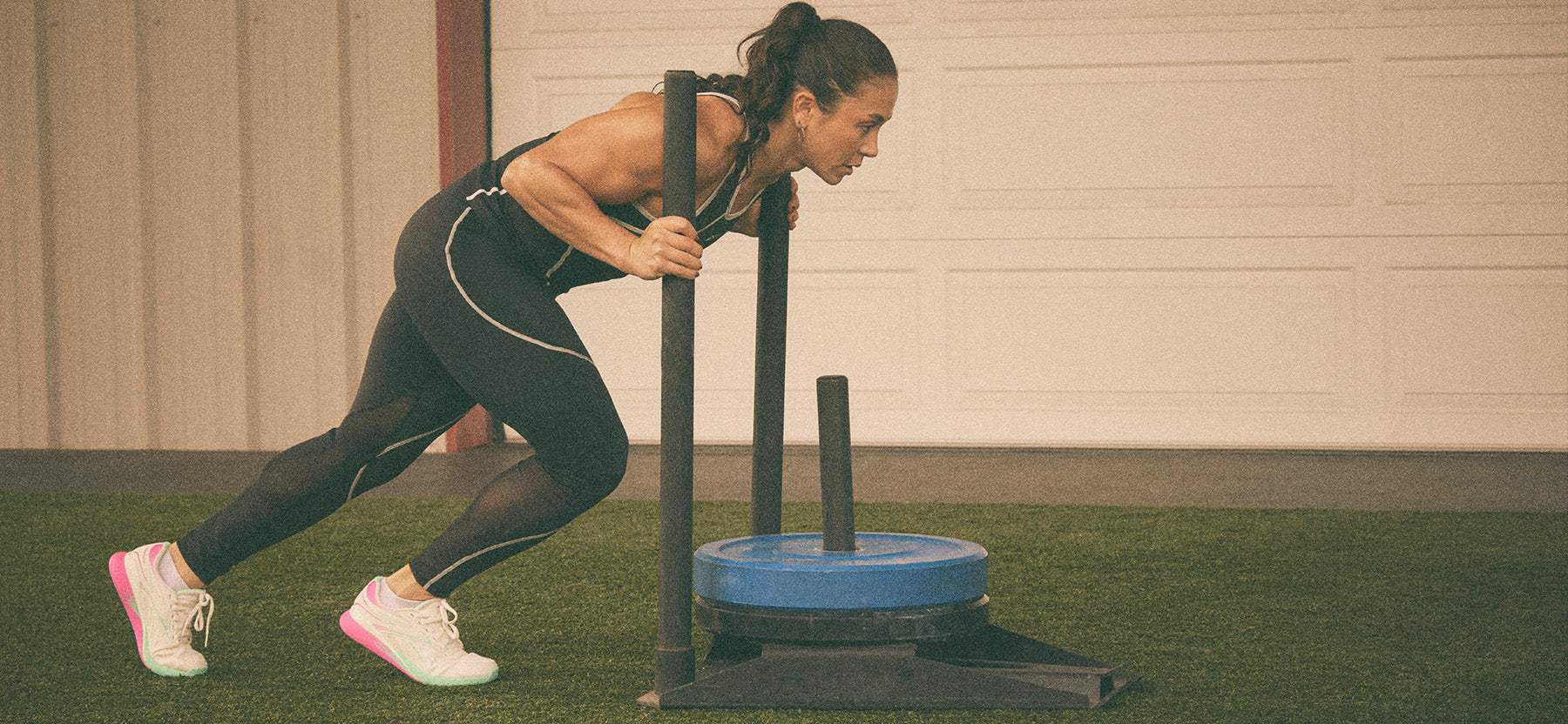 Woman performing a cable machine exercise in a gym setting