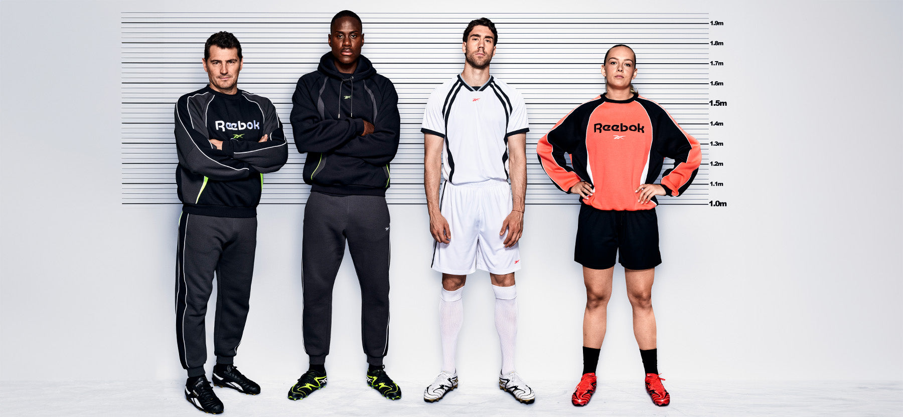 four soccer players against a white background