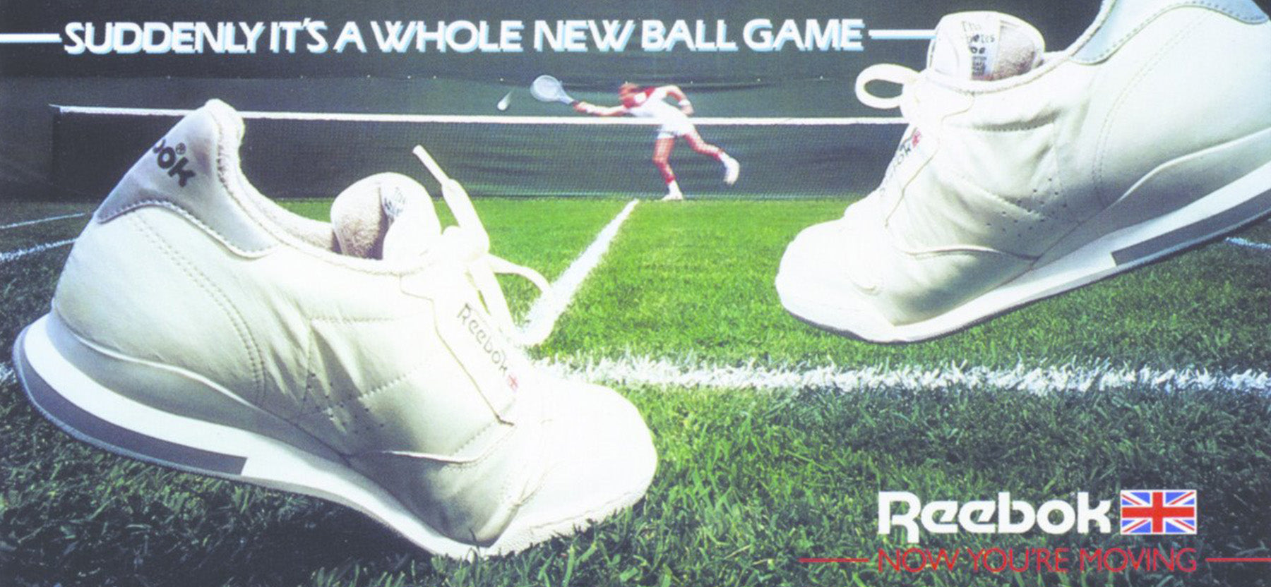 white reebok tennis shoes on green court