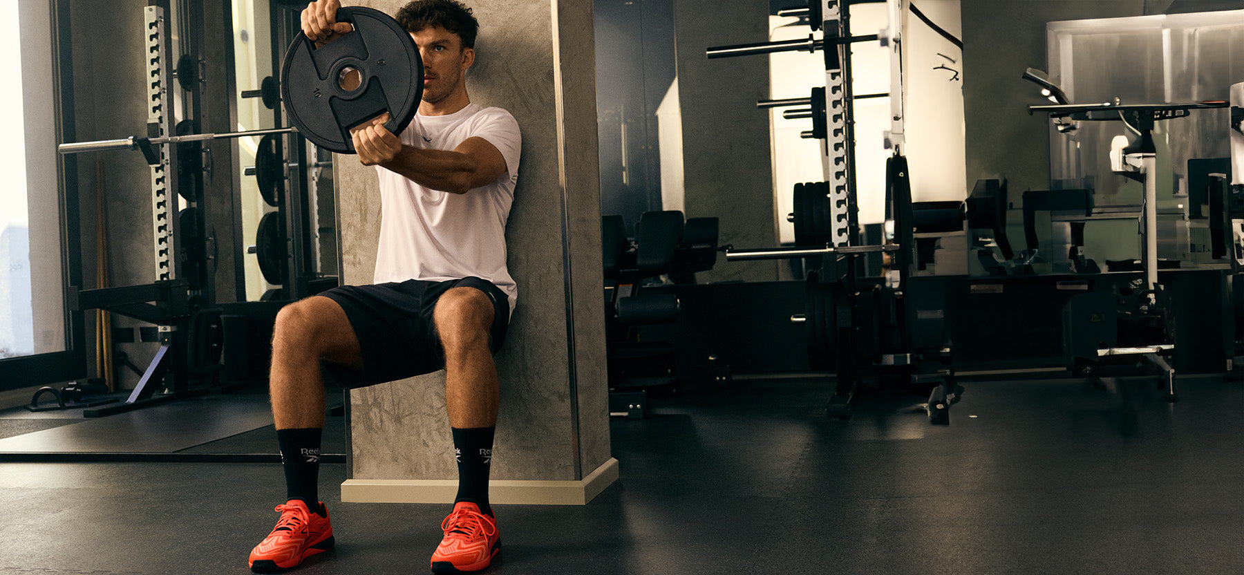Man performing a bench press in a gym setting