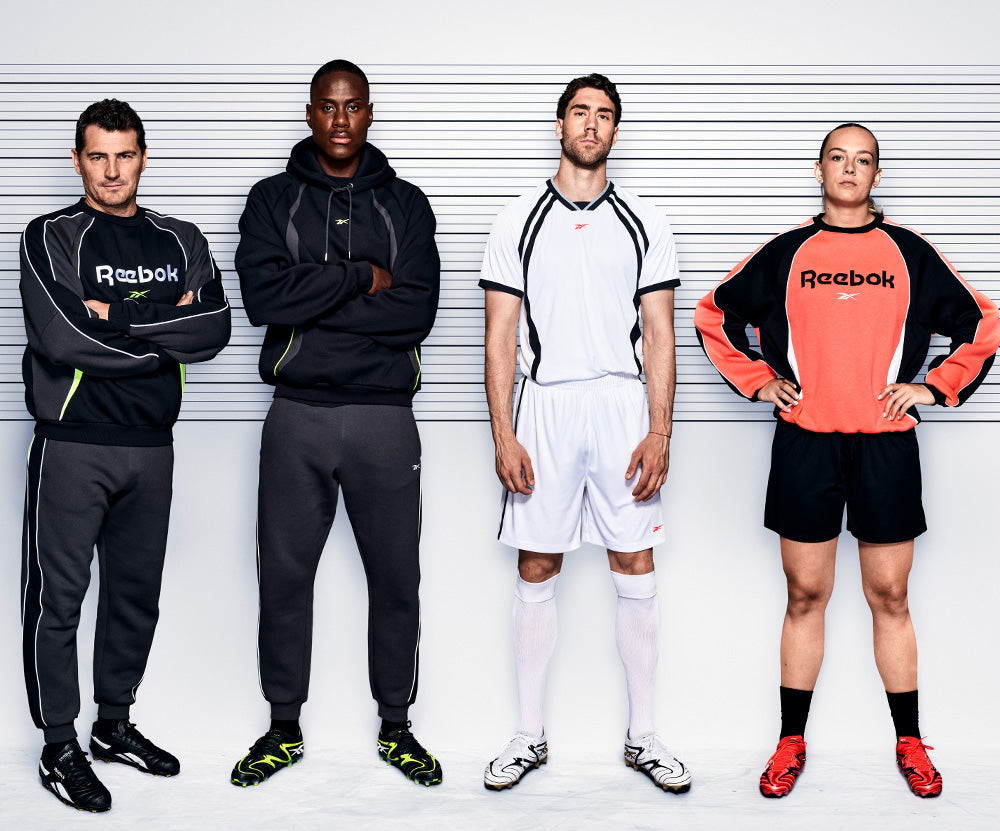 Four individuals wearing Reebok clothing against a white background
