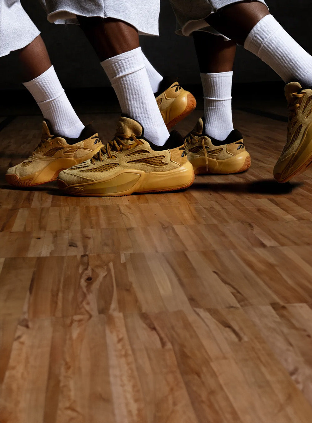 men with tan reebok on a basketball court 