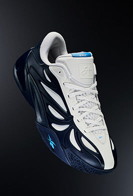 Black and white sneaker with blue accents on a dark background