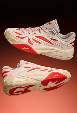 White and red athletic shoes with a visible brand logo on a gradient background