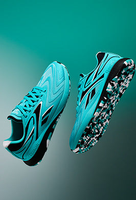Turquoise running shoes with black accents on a gradient background
