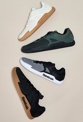 Four pairs of Reebok sneakers in different colors on a beige background