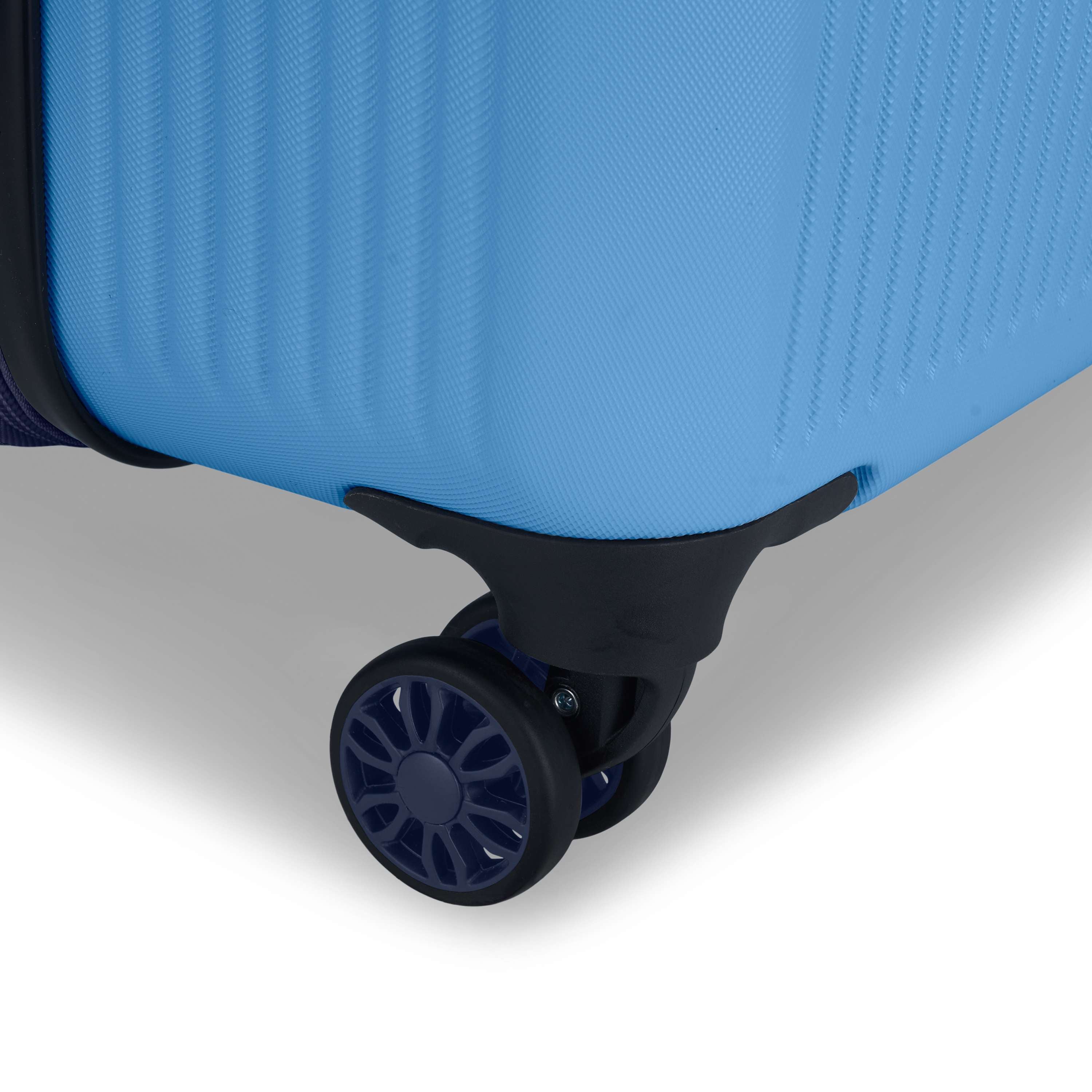 Close-up of the corner of the Reebok Action Duo 2 Piece Luggage Set in blue, highlighting its black and blue spinner wheel against a plain white background.