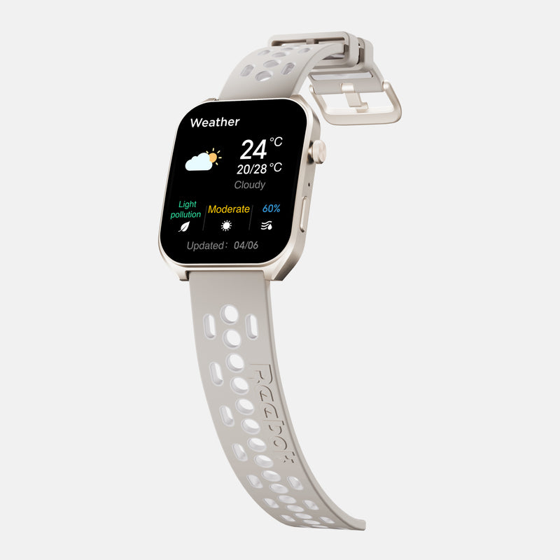 A beige Reebok Icon Smartwatch with a perforated silicone strap displays weather—24°C, cloudy, moderate light pollution, 60% humidity. This fitness tracker helps optimize your daily athletic performance.