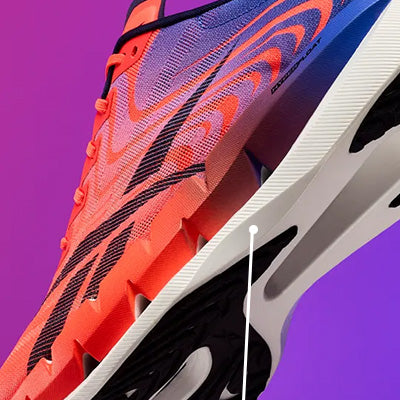 Close-up of a running shoe with a bright orange and purple upper, black side stripes, and a white midsole against a purple gradient background.