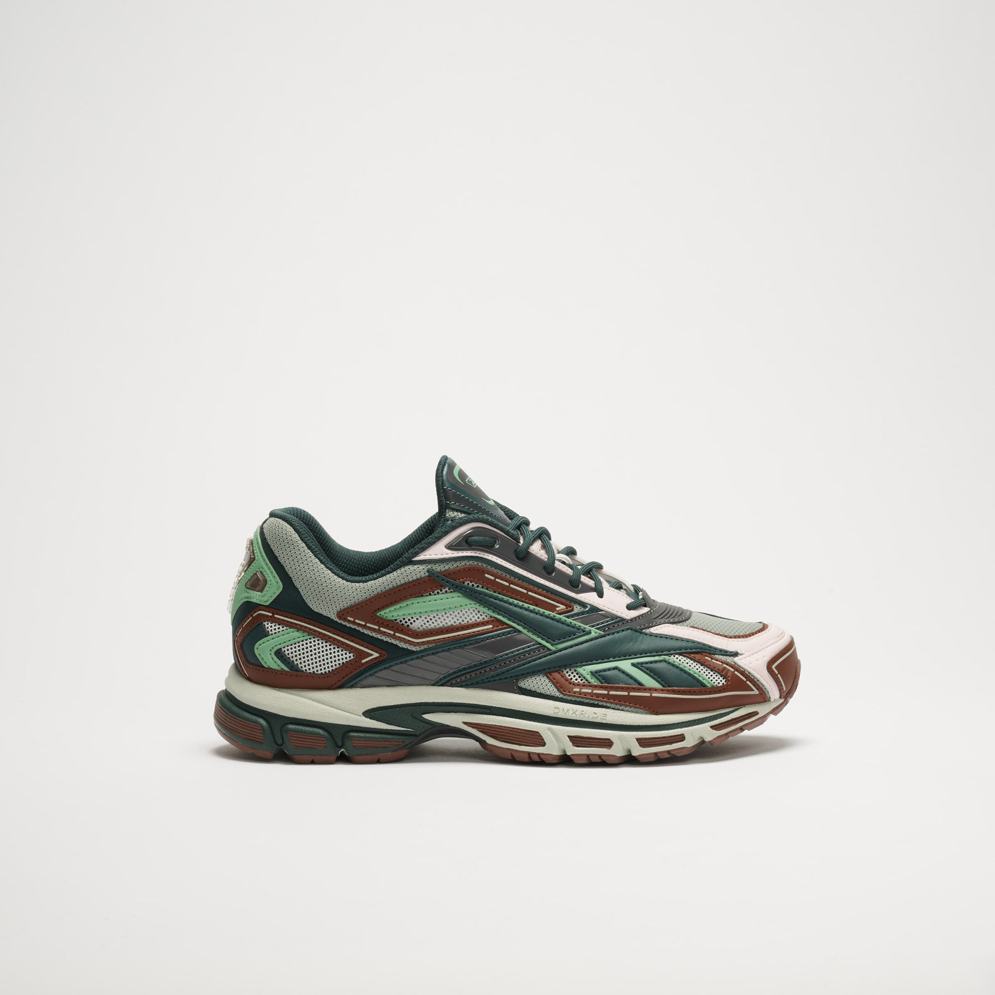 The Reebok Premier Road Ultra LTD Shoes are modern athletic sneakers with green, brown, and beige accents, a chunky sole with dual-density midsole, and mesh panels—shown on a plain white background.