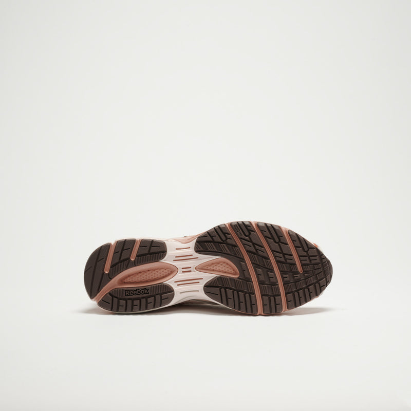 The image displays the bottom of Reebok Premier Road Ultra LTD Shoes, highlighting a black and pink rubber sole with textured tread, plus a dual-density midsole for superior grip, traction, flexibility, and cushioned support.