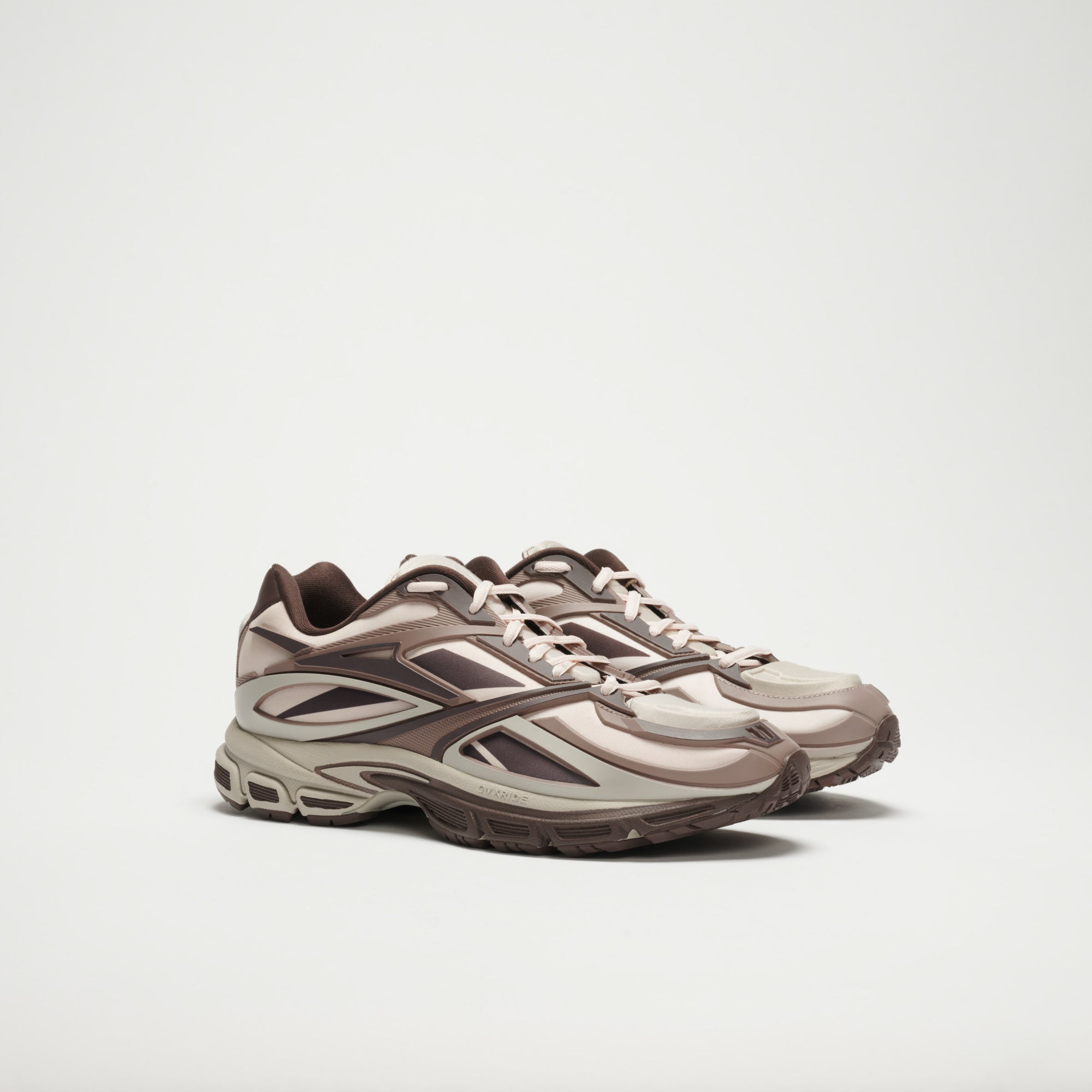 A pair of Reebok Premier Road Modern LTD Shoes in beige and brown with intricate patterns and thick textured soles, shown side by side on a plain white background.