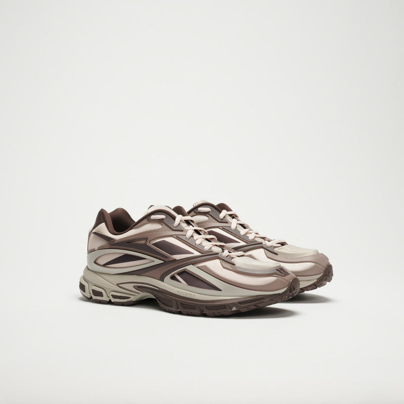 A pair of Reebok Premier Road Modern LTD Shoes in beige and brown with intricate patterns and thick textured soles, shown side by side on a plain white background.