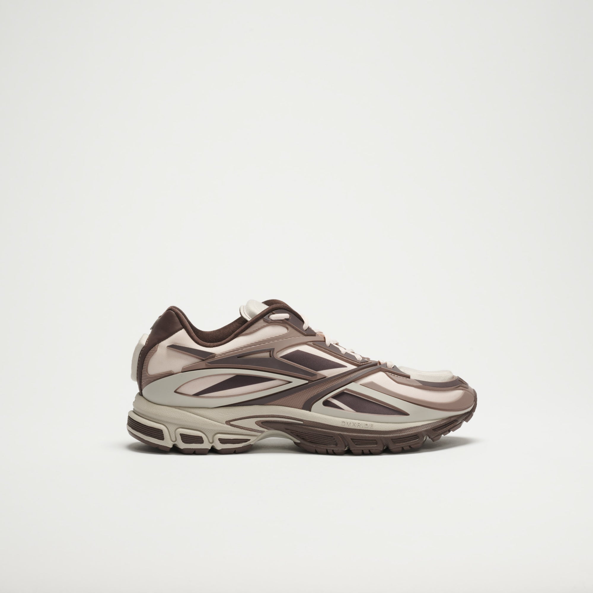 The Reebok Premier Road Modern LTD Shoes in beige, brown, and cream feature layered panels and a chunky sole with modern design details, shown against a plain white background.