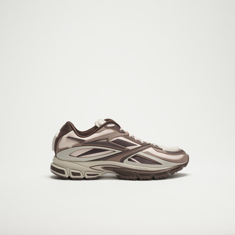 The Reebok Premier Road Modern LTD Shoes in beige, brown, and cream feature layered panels and a chunky sole with modern design details, shown against a plain white background.
