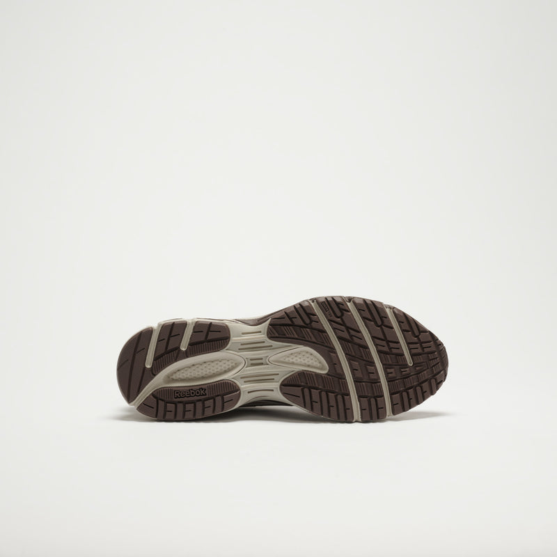 The image displays the sole of the Reebok Premier Road Modern LTD Shoes, featuring a brown and beige textured tread with the Reebok logo by the heel, captured against a plain white background.