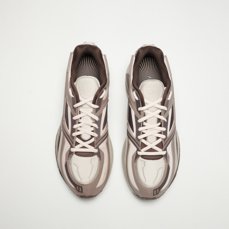 A pair of Reebok Premier Road Modern LTD Shoes in light beige and brown with white laces, seen from above on a plain white background.