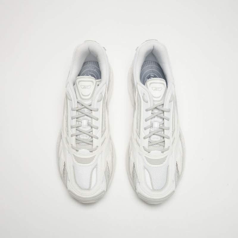 A pair of Reebok Premier Road Ultra LTD Shoes in white with gray accents, shown from above on a plain background. These sneakers feature mesh uppers, laces, visible stitching, and a dual-density midsole for comfort.