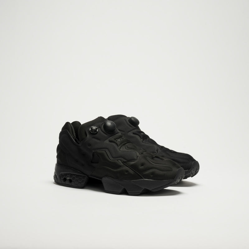 A pair of all-black Reebok Instapump Sliver LTD Shoes with a futuristic design, textured details, raised patterns, and pump buttons on the tongue for a custom fit, shown against a plain white background.
