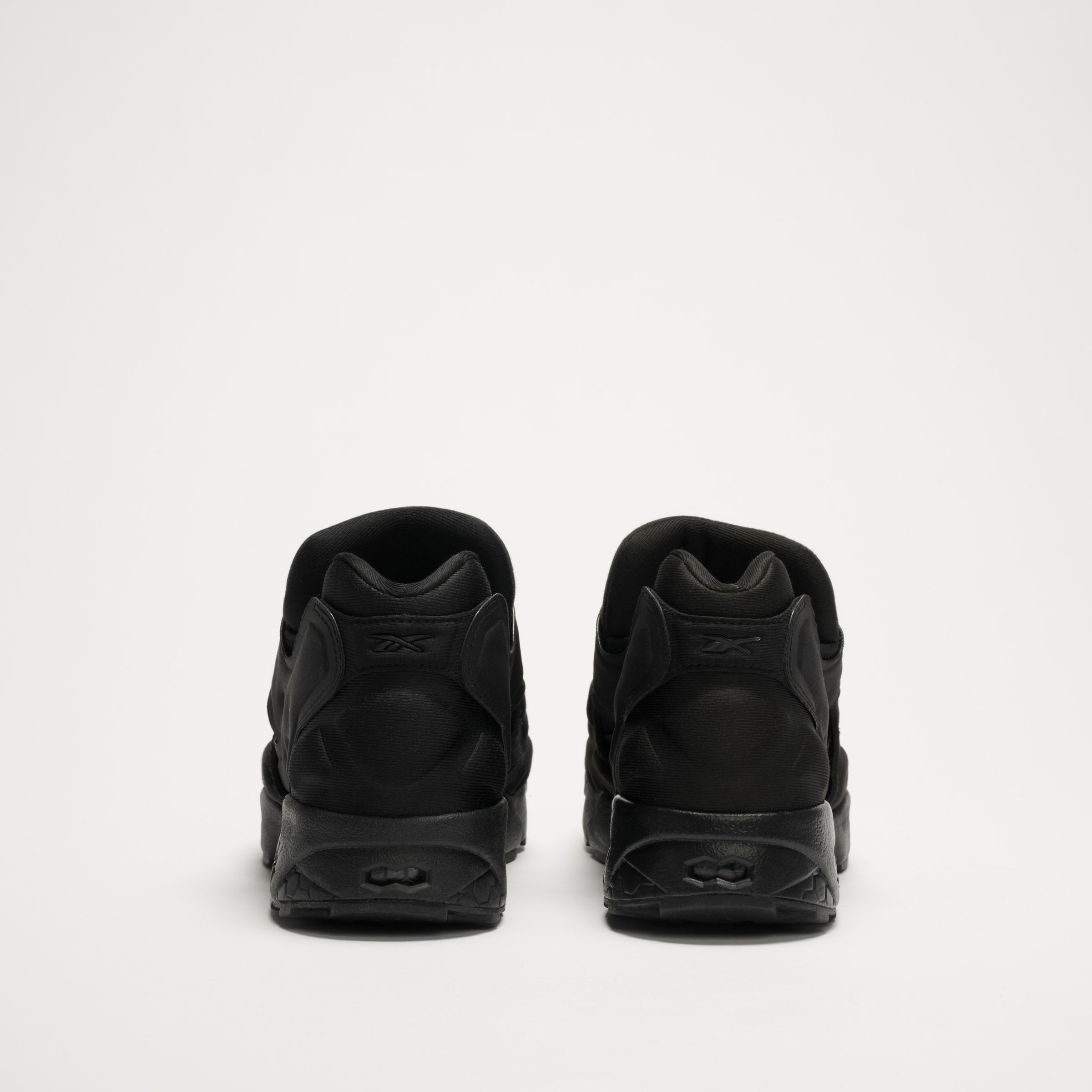 The Reebok Instapump Sliver LTD Shoes are shown from the back on a plain white background, placed side by side to highlight their heel and sole details.