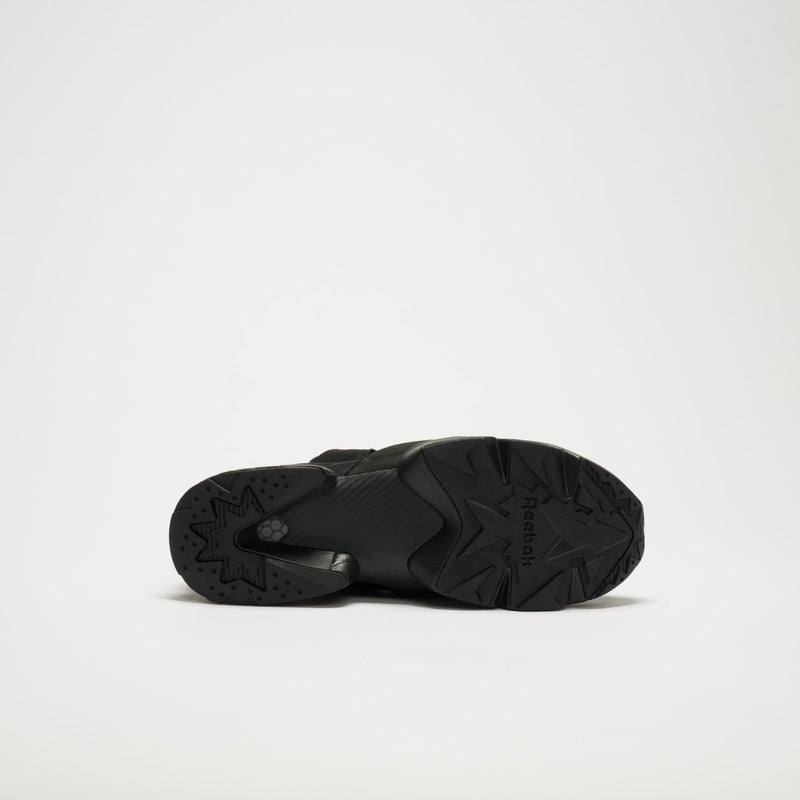 Bottom view of a single black Reebok Instapump Sliver LTD shoe with a chunky rubber sole, star-patterned tread, Hexalite cushioning, and the Reebok logo visible against a plain white background.