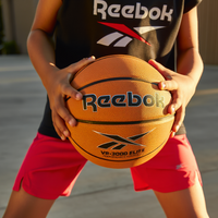 Child holding a Reebok basketball