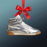 silver reebok hightop shoe with red ribbon