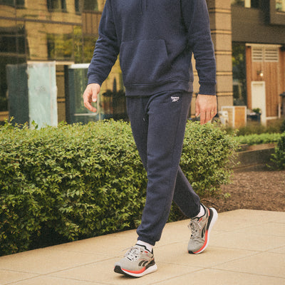 Image of man in sneakers walking on a path