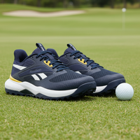 Navy blue golf shoes with white soles on a golf course