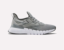 A gray athletic sneaker with a white, thick, textured sole. The shoe features a lace-up design and subtle geometric patterns on the side.