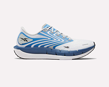 White and blue athletic running shoe with light blue and silver accents, featuring the Reebok logo on the side and a thick, cushioned sole, displayed on a plain light background.