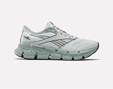 A light gray running shoe with a mint green sole, black Reebok logo, and mesh upper for breathability, shown from the side on a plain background.