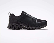 A black athletic sneaker with a mesh upper and a distinctive, wavy, segmented sole, displayed against a plain white background.