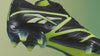 green and black soccer shoe in various shots