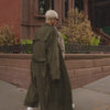 people on a city sidewalk wearing reebok classics white sneakers 