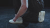 Belmont dancing against a black backdrop wearing white reebok classics 