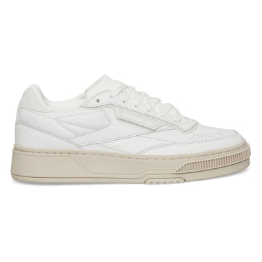 The Reebok Club C LTD Shoes are white low-top sneakers with a beige sole, perforated details, and white laces, shown in a side profile view—a timeless lifestyle classic inspired by tennis heritage.