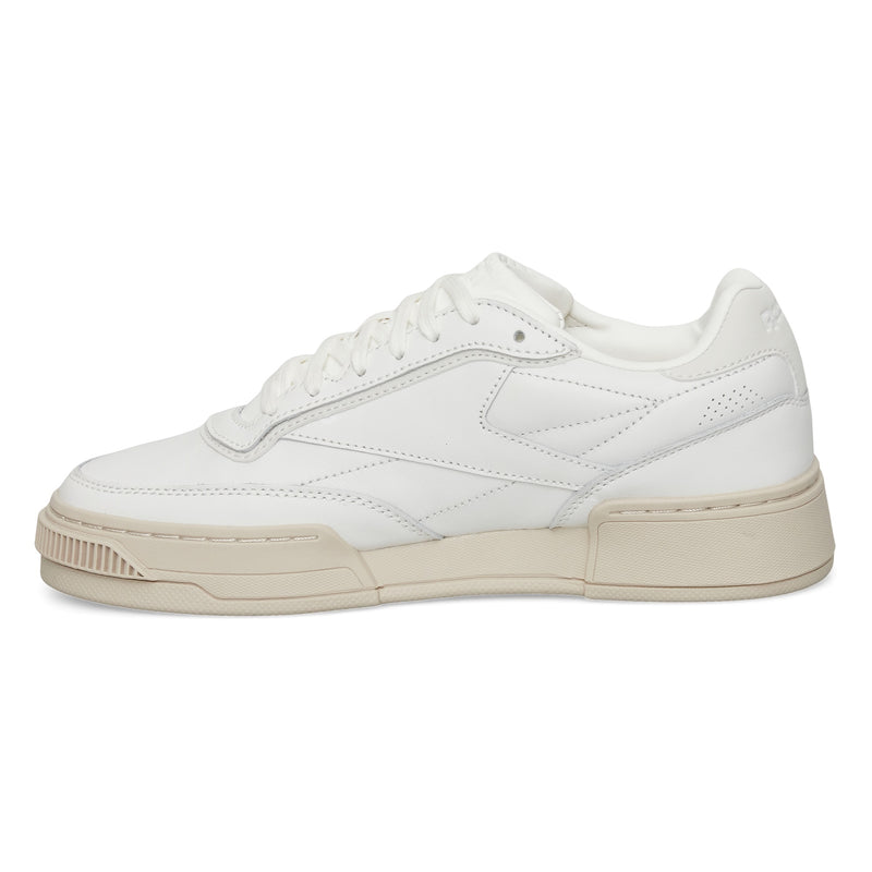 The Reebok Club C LTD Shoes are white low-top sneakers with a beige sole, white laces, and subtle stitching details—an iconic lifestyle classic inspired by the original Club C tennis shoe. Displayed on a plain white background.