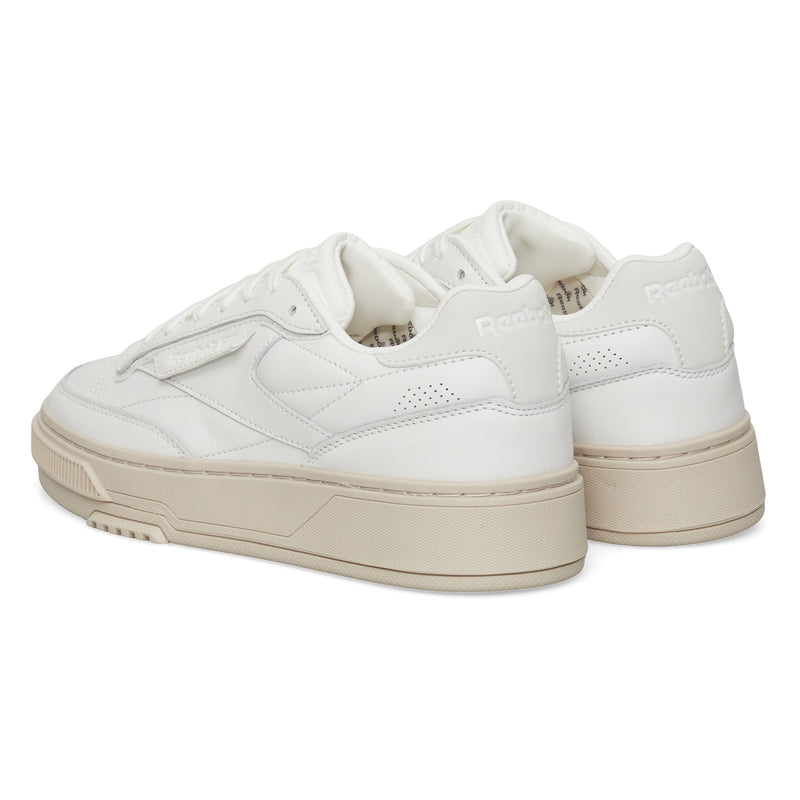 A pair of Reebok Club C LTD Shoes in white with beige soles, shown from the back and side, highlighting the brand logo and stitching on a clean white background—a timeless lifestyle classic.