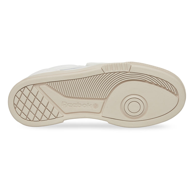 The image displays the beige rubber outsole of Reebok Club C LTD Shoes, featuring geometric tread patterns, the Reebok logo, and concentric circles near the toe for enhanced grip and traction.